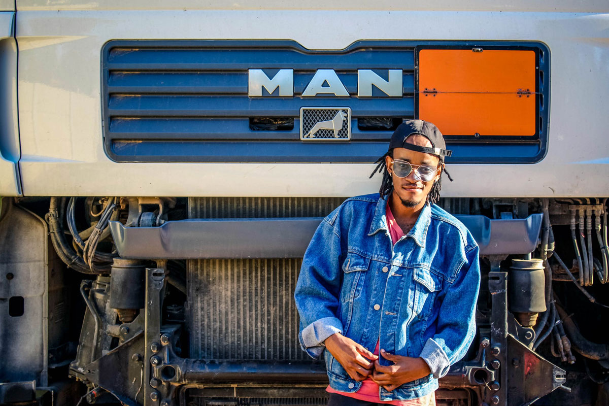 Five Facts About Being A Truck Driver That You May Not Know : Truck Driver standing in front of Man Truck